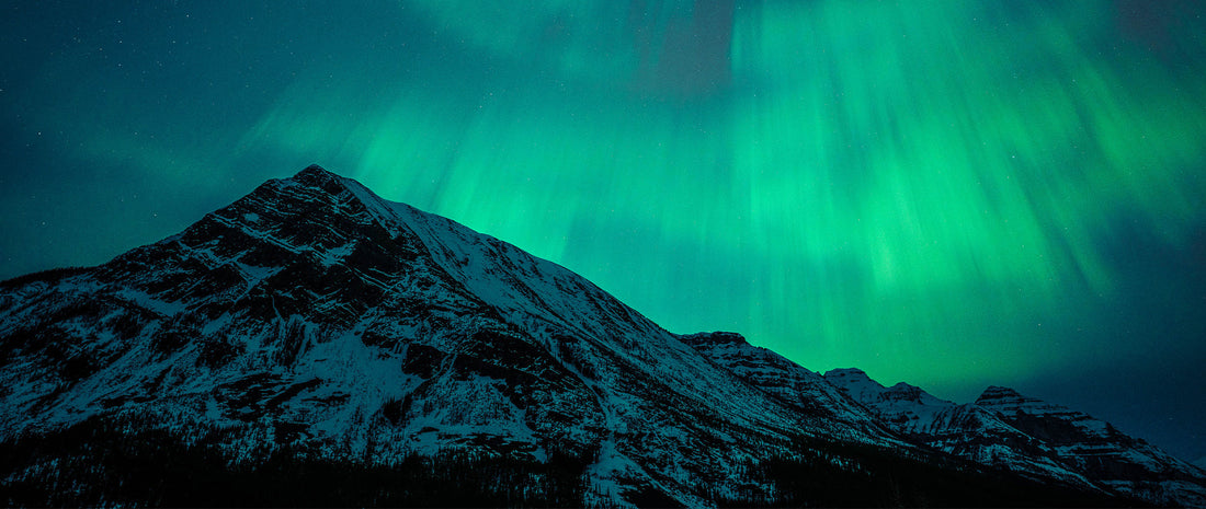The Northern Lights about a mountain ridge