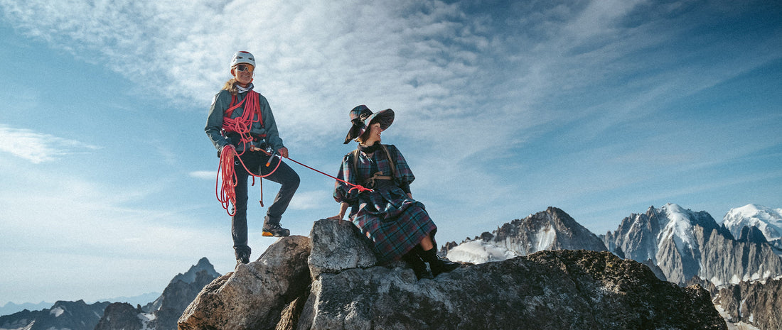 Two mountaineers atop a rocky peak