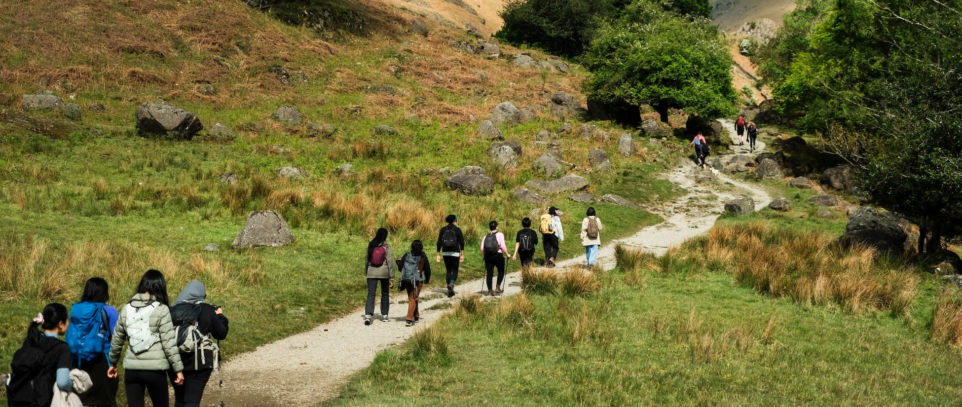 A group of women walking along a path in the British countryside